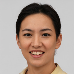 Joyful asian young-adult female with short  brown hair and brown eyes