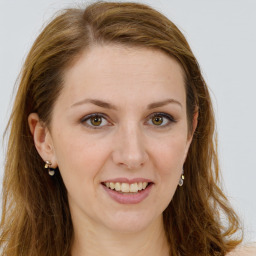 Joyful white young-adult female with long  brown hair and green eyes