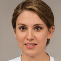 Joyful white adult female with medium  brown hair and brown eyes