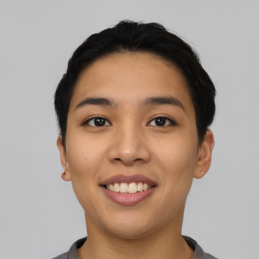 Joyful asian young-adult female with short  black hair and brown eyes