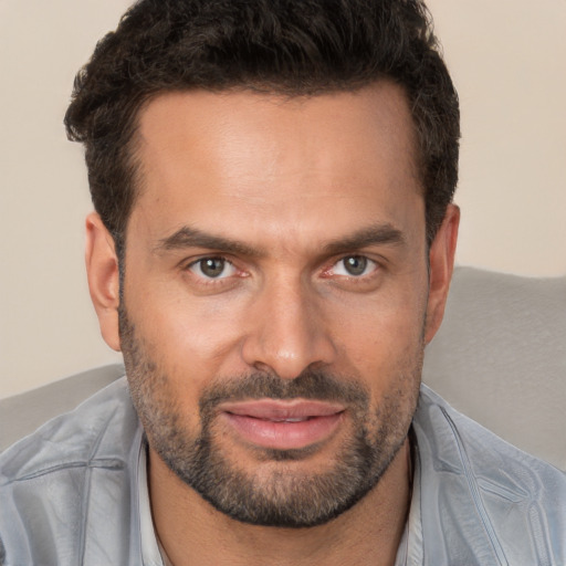 Joyful white adult male with short  brown hair and brown eyes