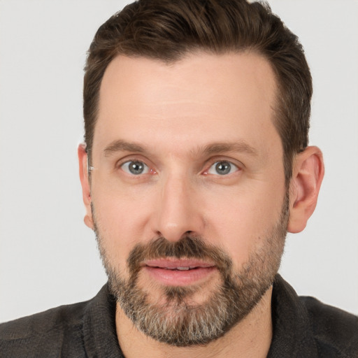 Joyful white adult male with short  brown hair and brown eyes