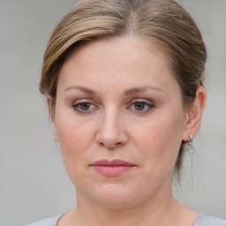 Joyful white young-adult female with medium  brown hair and blue eyes