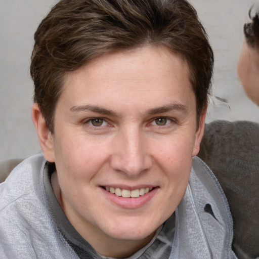 Joyful white young-adult female with short  brown hair and grey eyes