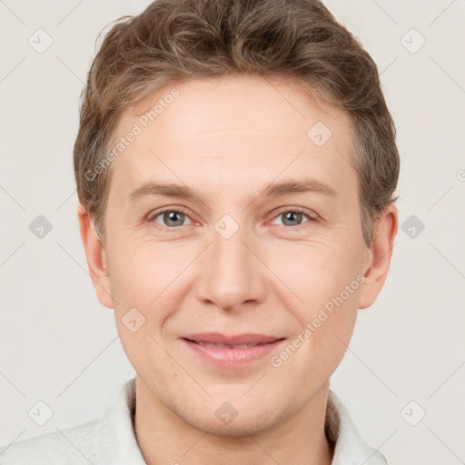 Joyful white adult male with short  brown hair and grey eyes