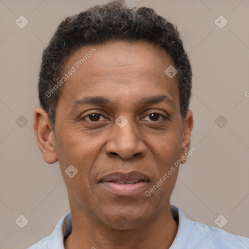 Joyful latino adult male with short  brown hair and brown eyes