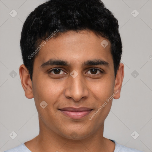 Joyful latino young-adult male with short  brown hair and brown eyes