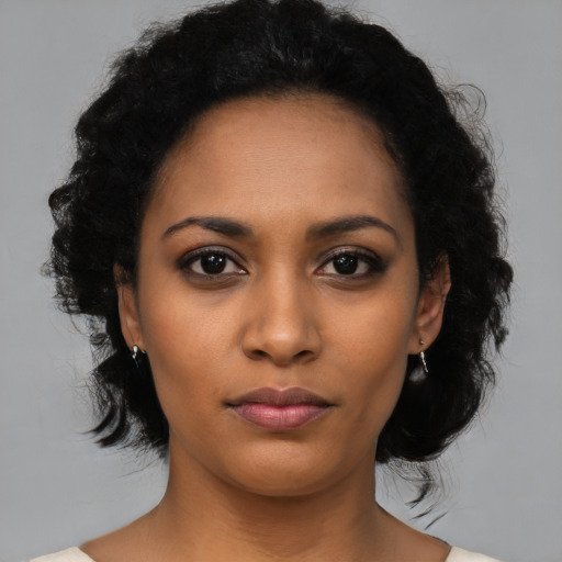 Joyful latino young-adult female with medium  black hair and brown eyes