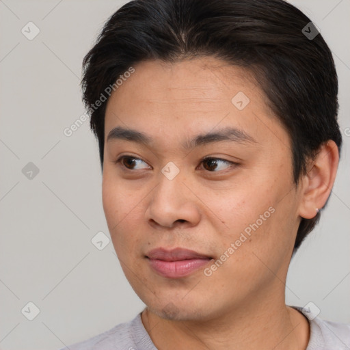 Joyful asian young-adult male with short  brown hair and brown eyes