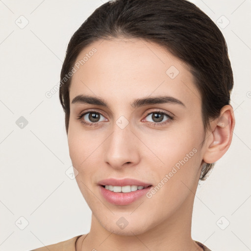 Joyful white young-adult female with short  brown hair and brown eyes