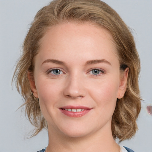 Joyful white young-adult female with medium  brown hair and blue eyes