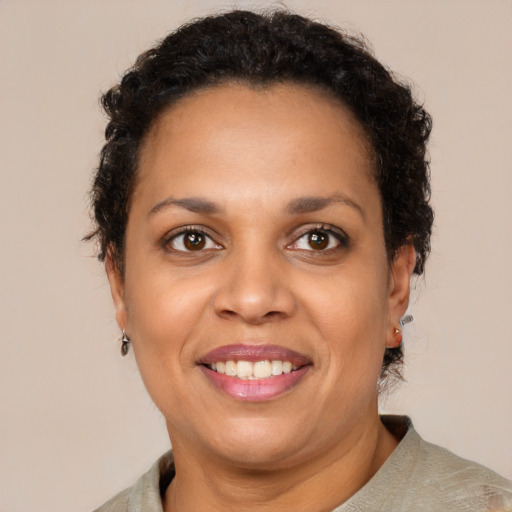 Joyful black adult female with short  brown hair and brown eyes