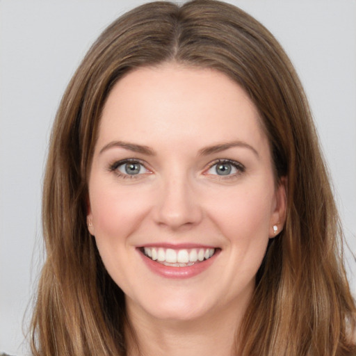 Joyful white young-adult female with long  brown hair and grey eyes