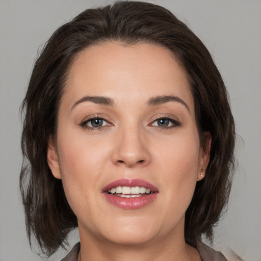 Joyful white young-adult female with medium  brown hair and brown eyes