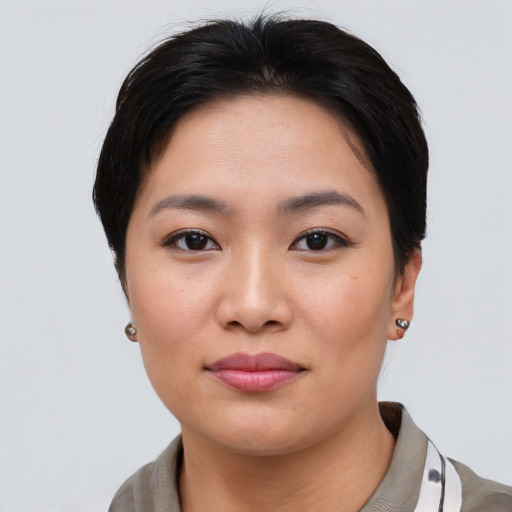 Joyful asian young-adult female with short  brown hair and brown eyes