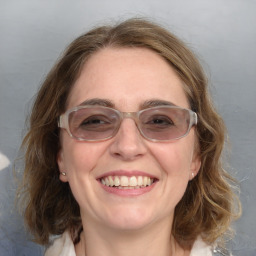 Joyful white young-adult female with medium  brown hair and blue eyes