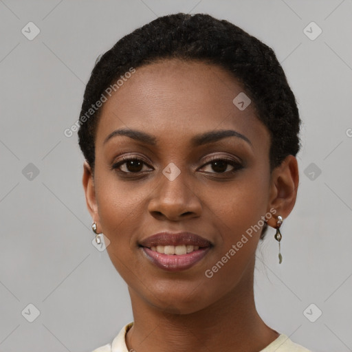 Joyful black young-adult female with short  black hair and brown eyes