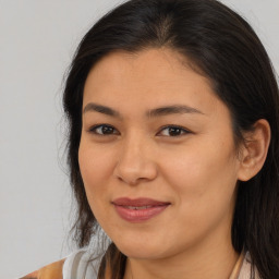 Joyful asian young-adult female with long  brown hair and brown eyes