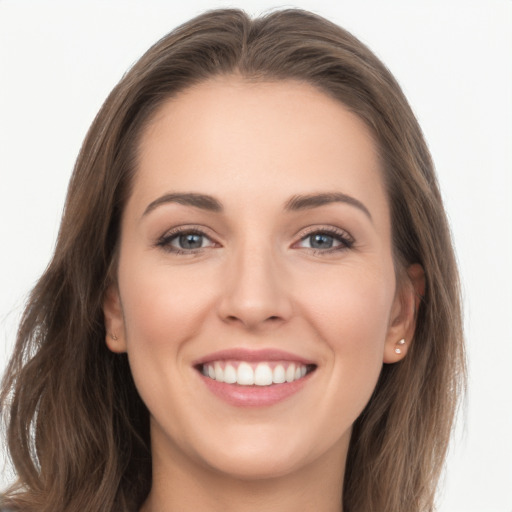 Joyful white young-adult female with long  brown hair and grey eyes