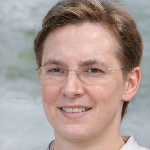 Joyful white adult female with short  brown hair and grey eyes