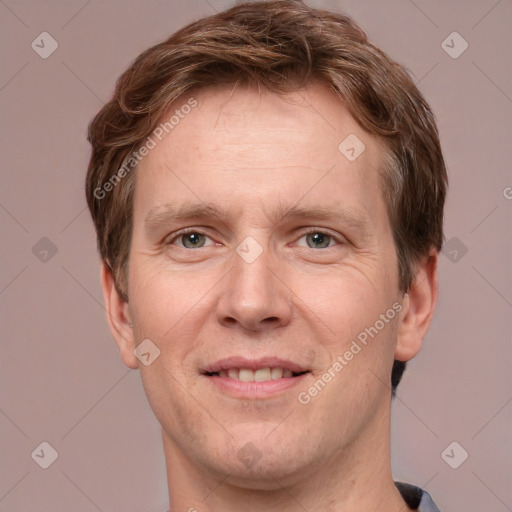 Joyful white adult male with short  brown hair and grey eyes