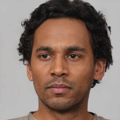 Neutral latino adult male with short  black hair and brown eyes