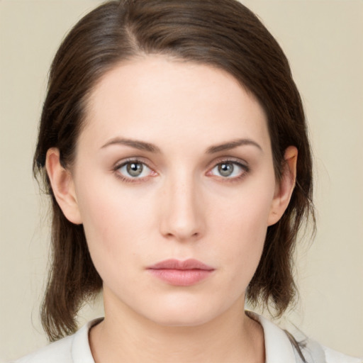 Neutral white young-adult female with medium  brown hair and green eyes