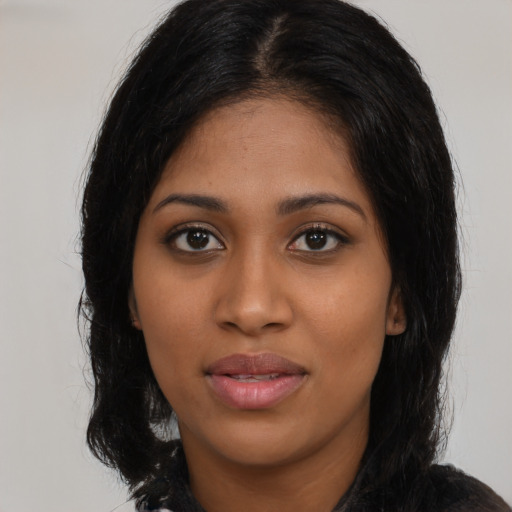 Joyful latino young-adult female with long  black hair and brown eyes