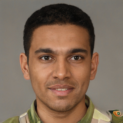 Joyful latino young-adult male with short  brown hair and brown eyes