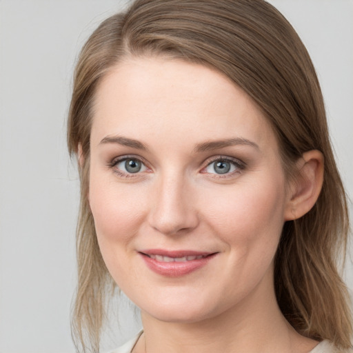 Joyful white young-adult female with medium  brown hair and blue eyes