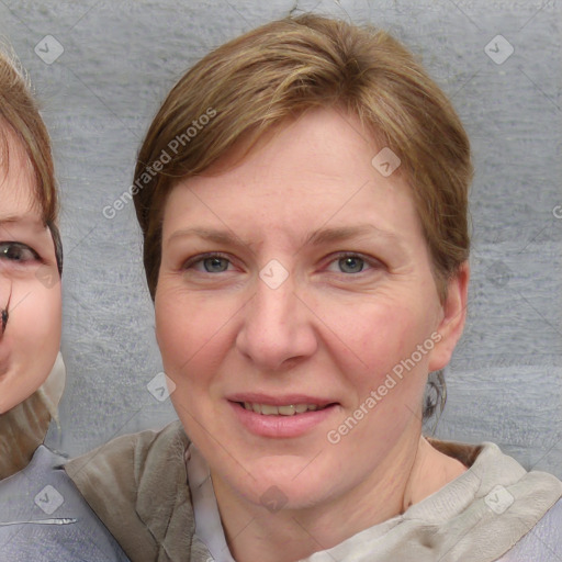 Joyful white adult female with medium  brown hair and blue eyes