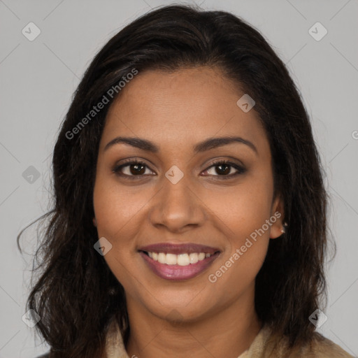 Joyful black young-adult female with long  brown hair and brown eyes