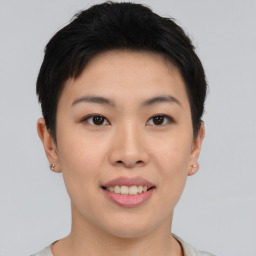 Joyful asian young-adult female with short  brown hair and brown eyes