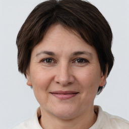 Joyful white adult female with short  brown hair and brown eyes