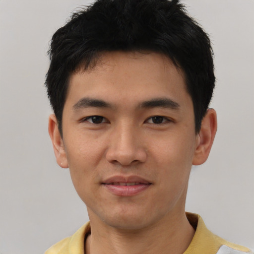 Joyful asian young-adult male with short  black hair and brown eyes