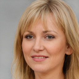 Joyful white adult female with long  brown hair and brown eyes