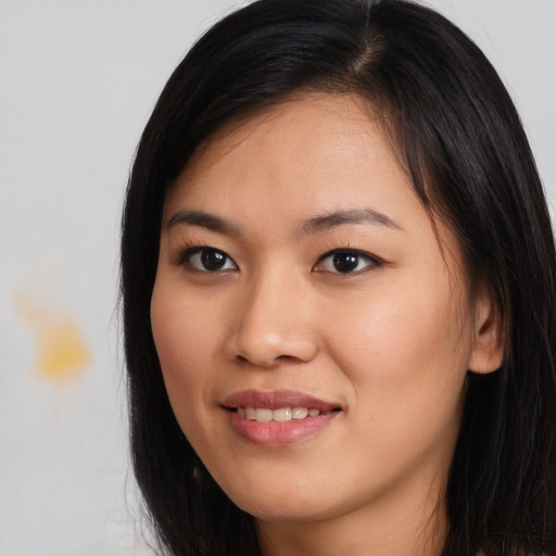 Joyful asian young-adult female with long  brown hair and brown eyes