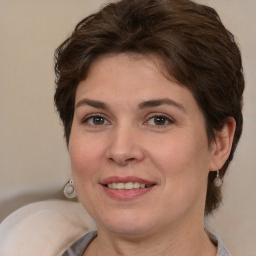 Joyful white adult female with medium  brown hair and brown eyes