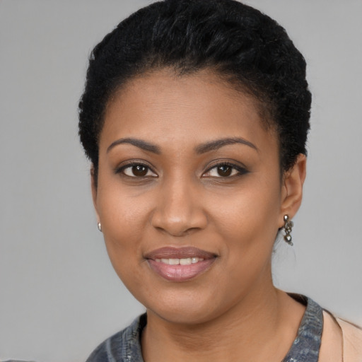 Joyful black young-adult female with short  black hair and brown eyes