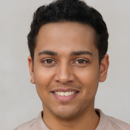 Joyful latino young-adult male with short  brown hair and brown eyes