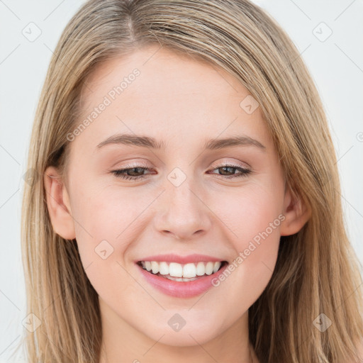 Joyful white young-adult female with long  brown hair and blue eyes