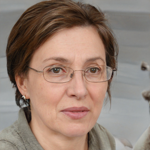 Joyful white middle-aged female with medium  brown hair and blue eyes