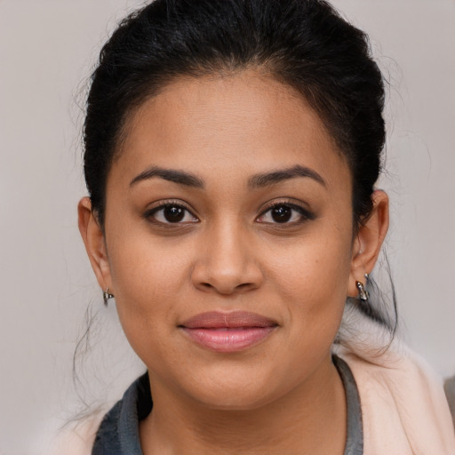 Joyful latino young-adult female with medium  brown hair and brown eyes