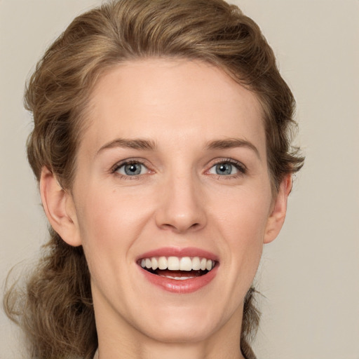 Joyful white young-adult female with medium  brown hair and green eyes