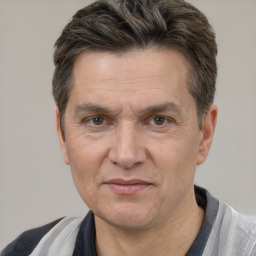 Joyful white middle-aged male with short  brown hair and brown eyes