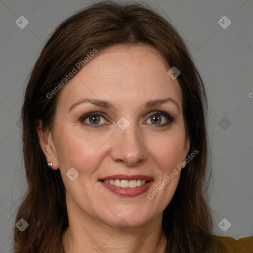 Joyful white adult female with long  brown hair and brown eyes