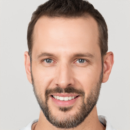 Joyful white young-adult male with short  brown hair and brown eyes