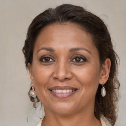 Joyful white adult female with medium  brown hair and brown eyes