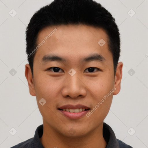 Joyful asian young-adult male with short  black hair and brown eyes