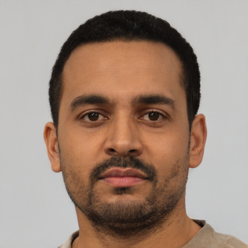 Neutral latino young-adult male with short  black hair and brown eyes